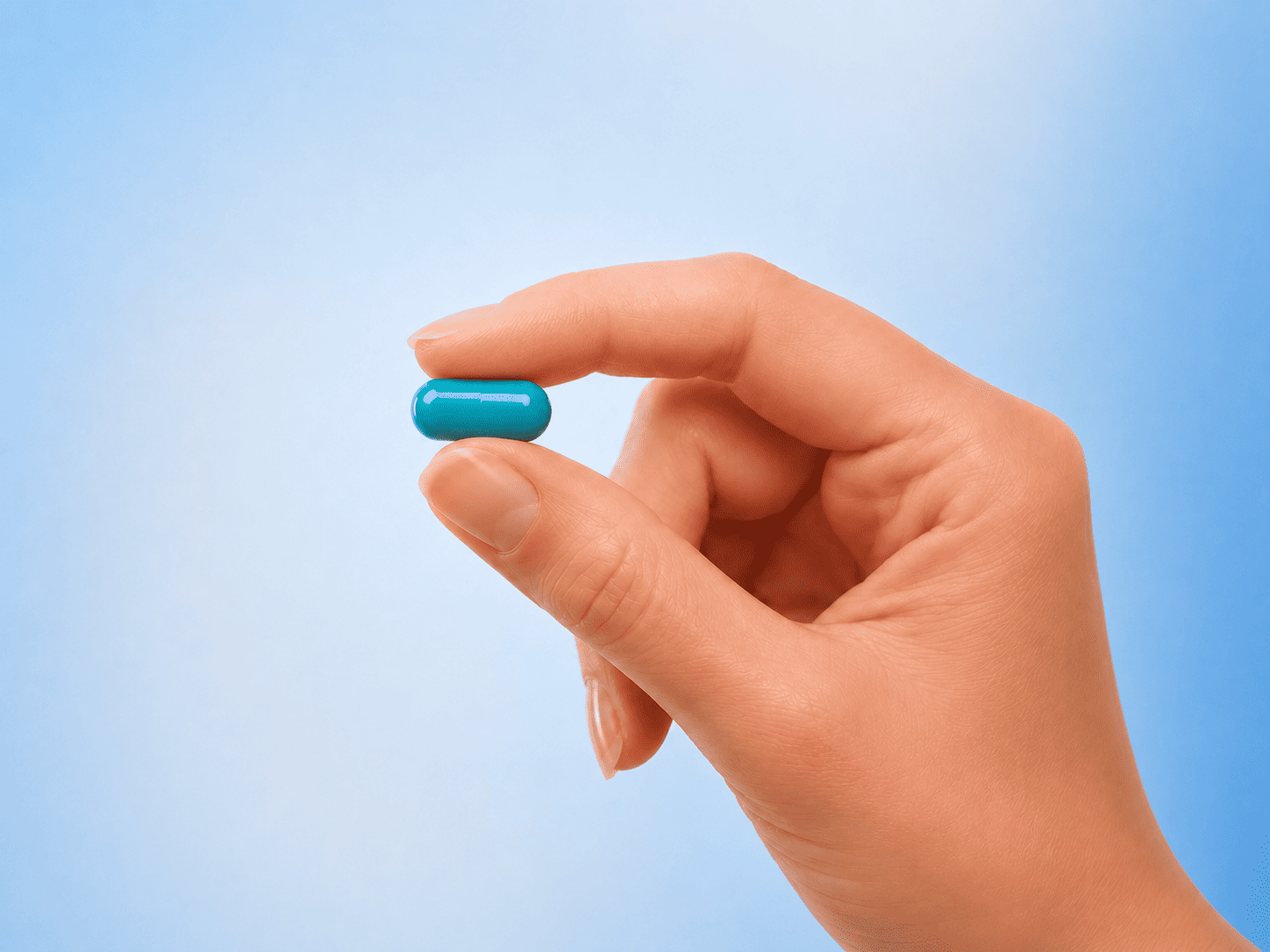 Orlistat 120mg capsule held between two fingers