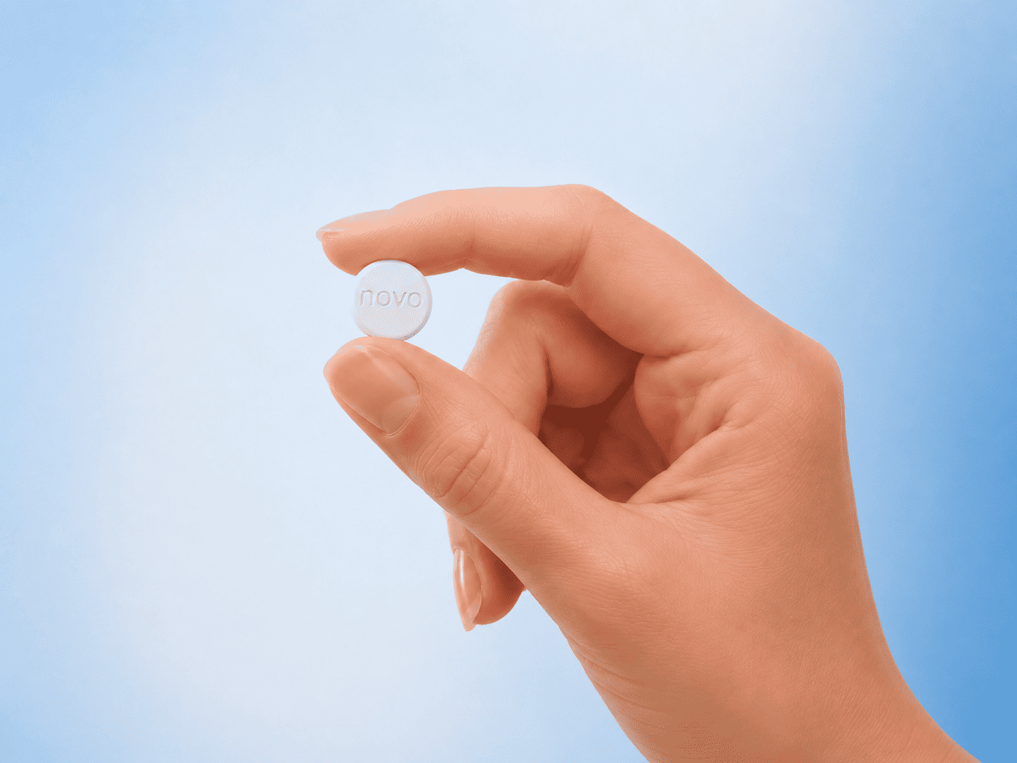 Wegovy Pill (oral semaglutide) tablet held between two fingers